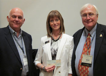 Photo: Debbie Brown of the Florida Chiropractic Foundation presents a check to Palmer Vice Chancellor for Advancement Bob Lee (left) and Florida Campus President Peter Martin, D.C., during the recent FCA convention. 