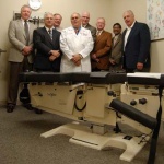 Cox Technic presents table to Palmer College of Chiropractic