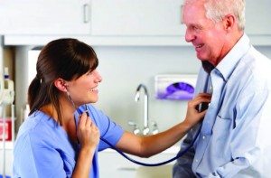 Physician extender listening to patient heart