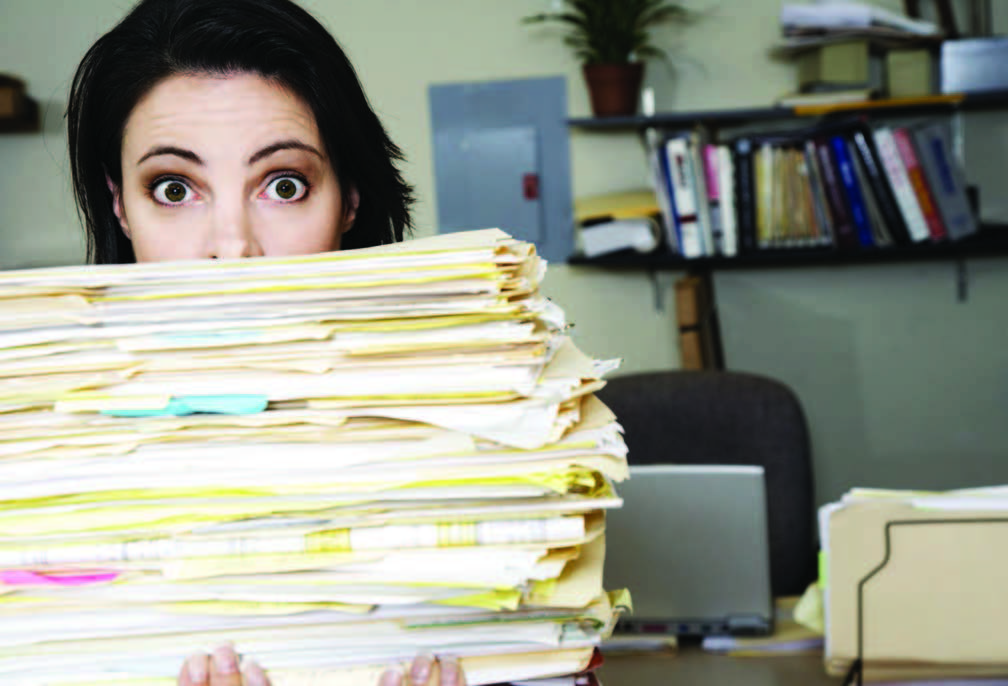 woman holding large stack of papers, interview