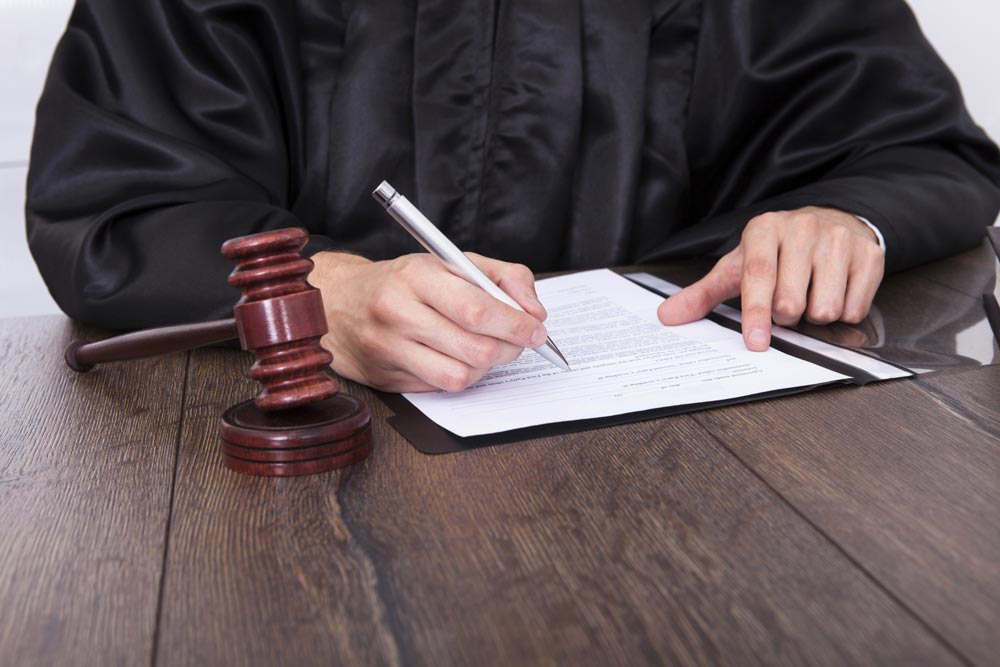 judge signing paper