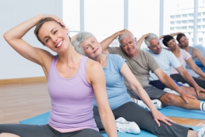 Class stretching neck in row at yoga class